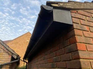 Old and worn-out fascia, soffit, and guttering on a house in Ilford prior to replacement.
