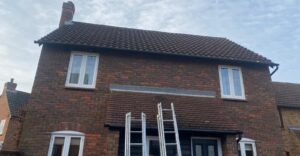 Old and worn-out fascia, soffit, and guttering on a house in Ilford prior to replacement.