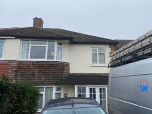 Old and worn-out fascia, soffit, and guttering on a house in Epping, Essex, prior to replacement.