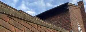 Old and worn-out fascia, soffit, and guttering on a house in Ilford prior to replacement.