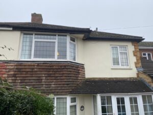 Old and worn-out fascia, soffit, and guttering on a house in Epping, Essex, prior to replacement.