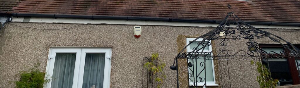 Old timber fascia, soffit and guttering at the back of the property in Chingford before roofline replacement.