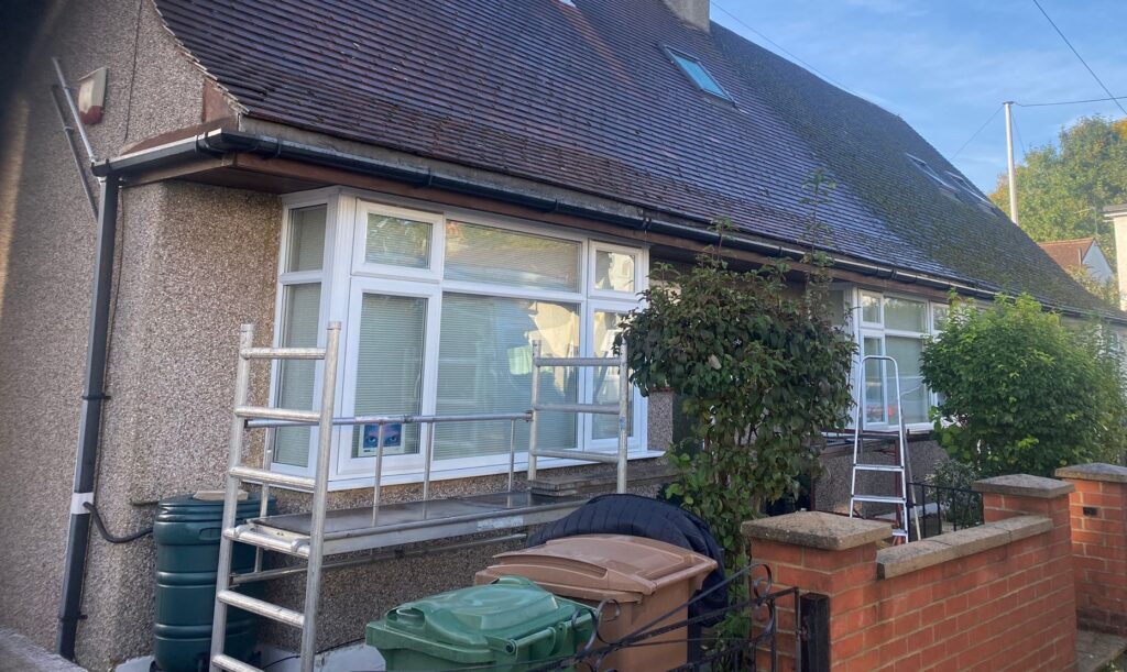 The front of the Chingford property showing the old timber fascia, soffit and worn guttering before replacement.