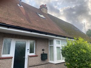 Freshly installed white UPVC fascia and soffit with black guttering at the front of the Chingford property.