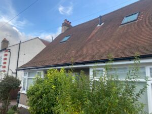 Close-up of the new white UPVC soffit and black guttering providing a clean finish on the Chingford home.