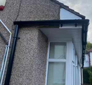 Completed side view of the Chingford property featuring new white UPVC fascia and soffit with black guttering.