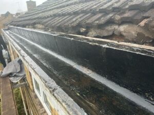 Concrete gutter lined with fibreglass, creating a watertight base before the top coat is applied.