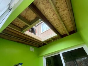 Image showing strengthening work and OSB boards being fitted during flat roof replacement project.