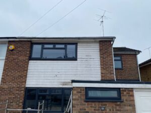 Existing front elevation before replacement fascia, soffit, guttering and cladding in Ware
