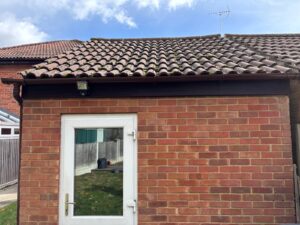 Rear view of garage with new fascia soffit and guttering in rosewood finish