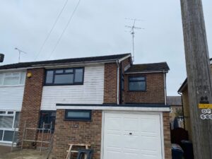 Front elevation before fascia, soffit, guttering and cladding replacement in Ware