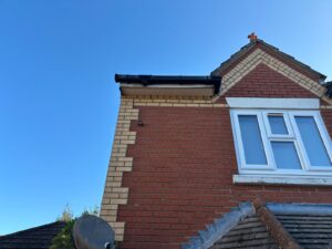 Front of property before roofline replacement showing existing fascia soffit and guttering