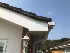 Underneath view of existing soffit and guttering before installation work